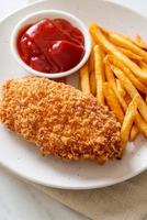 Fried chicken breast fillet steak with French fries and ketchup photo