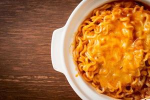 Spicy instant noodle bowl with mozzarella cheese photo