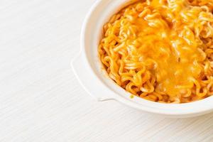 Spicy instant noodle bowl with mozzarella cheese photo