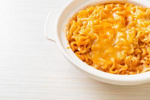 Spicy instant noodle bowl with mozzarella cheese photo