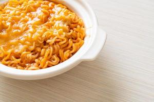 Spicy instant noodle bowl with mozzarella cheese photo
