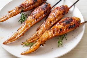 Grilled or barbecue chicken wings skewer with sticky rice photo