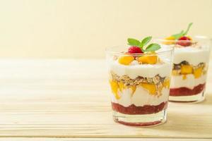 Homemade fresh mango and fresh raspberry with yogurt and granola - healthy food style photo