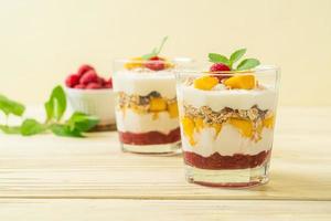 Homemade fresh mango and fresh raspberry with yogurt and granola - healthy food style photo