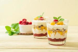 Homemade fresh mango and fresh raspberry with yogurt and granola - healthy food style photo