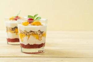 Homemade fresh mango and fresh raspberry with yogurt and granola - healthy food style photo