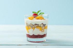 Homemade fresh mango and fresh raspberry with yogurt and granola - healthy food style photo