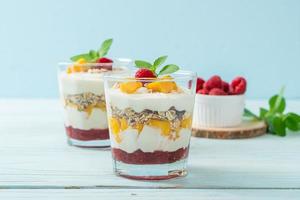 Homemade fresh mango and fresh raspberry with yogurt and granola - healthy food style photo