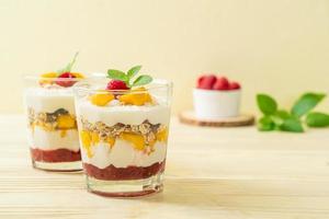 Homemade fresh mango and fresh raspberry with yogurt and granola - healthy food style photo