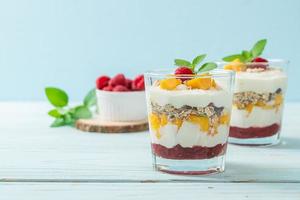 Homemade fresh mango and fresh raspberry with yogurt and granola - healthy food style photo