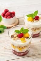 Homemade fresh mango and fresh raspberry with yogurt and granola - healthy food style photo