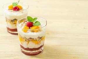 Homemade fresh mango and fresh raspberry with yogurt and granola - healthy food style photo