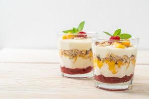 Homemade fresh mango and fresh raspberry with yogurt and granola - healthy food style photo