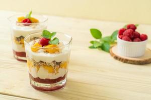 Homemade fresh mango and fresh raspberry with yogurt and granola - healthy food style photo