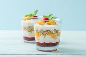 Homemade fresh mango and fresh raspberry with yogurt and granola - healthy food style photo