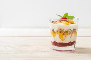 Homemade fresh mango and fresh raspberry with yogurt and granola - healthy food style photo
