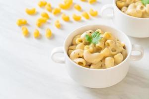 Macaroni and cheese with herbs in a bowl photo