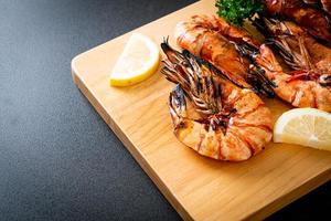 Grilled tiger prawns or shrimps with lemon on a plate