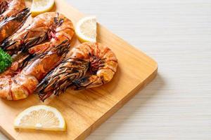Grilled tiger prawns or shrimps with lemon on a plate