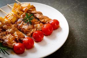 Grilled pork barbecue skewer on plate photo