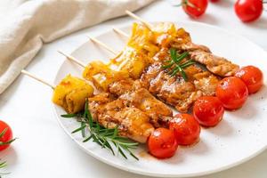 Grilled pork barbecue skewer on plate photo