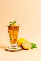 Glass of ice lemon tea with mint photo