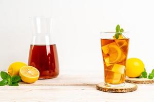 Glass of ice lemon tea with mint photo