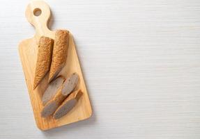 Fried Chinese fish cake or fish ball line on wood board photo