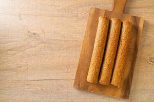 Fried Chinese fish cake or fish ball line on wood board photo