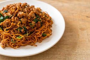Stir-fried instant noodles with Thai basil and minced pork - Asian food style photo