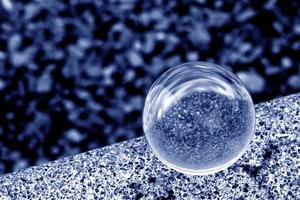 A lens ball in blue monochrome photo