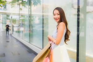 Portrait beautiful young asian woman happy and smile with shopping bag from department store photo