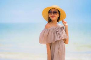 Portrait beautiful young asian woman happy smile relax on the tropical beach sea ocean
