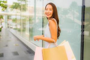 Portrait beautiful young asian woman happy and smile with shopping bag from department store photo