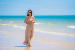 Portrait beautiful young asian woman happy smile relax on the tropical beach sea ocean photo