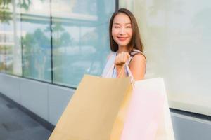 Portrait beautiful young asian woman happy and smile with shopping bag from department store photo