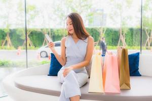 Portrait beautiful young asian woman happy and smile with shopping bag from department store photo