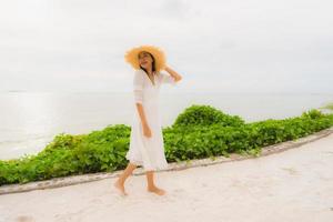 Portrait beautiful asian woman wear hat with smile happy leisure on the beach and sea in holiday vacation photo