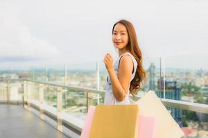 Portrait beautiful young asian woman happy and smile with shopping bag from department store photo