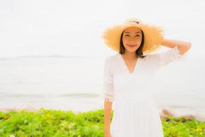 Portrait beautiful asian woman wear hat with smile happy leisure on the beach and sea in holiday vacation photo