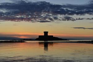 St Ouens Bay Jersey UK 19th century tower at sunset photo