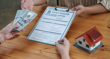 Businessman and estate agent signing a document for house deal photo