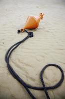Buoy on beach sand photo