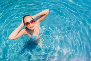 Portrait beautiful young asian woman smile happy relax and leisure in the swimming pool