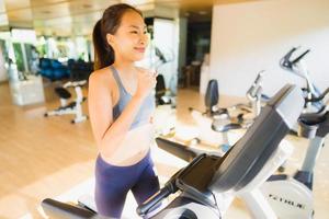 Portrait asian woman exercising and workout by running in gym photo