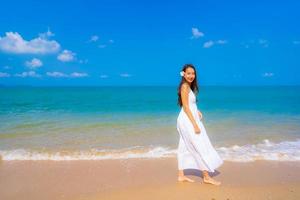 Portrait beautiful young asian woman happy smile leisure on the beach sea and ocean photo