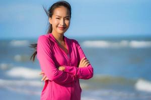 Portrait beautiful young asian woman running and exercising on the tropical outdoor nature beach sea ocean photo