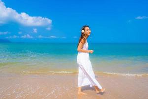 Portrait beautiful young asian woman happy smile leisure on the beach sea and ocean photo