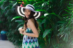 Portrait beautiful young asian woman smile and happy around outdoor garden photo