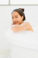 Portrait beautiful young asian woman take a bathtub in bathroom photo